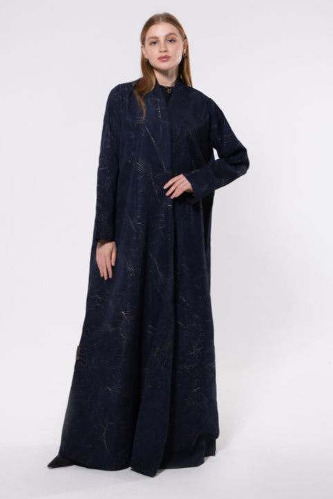 Navy abaya with gold embellishments, made from rich, flowy fabric with a soft gleam, exuding elegance and luxury.