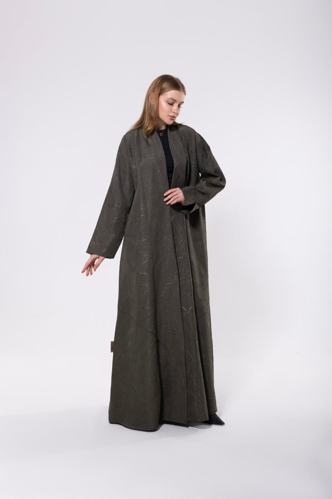 Olive green abaya with a gold sheen, made from a textured premium blend fabric, offering an elegant and luxurious look.