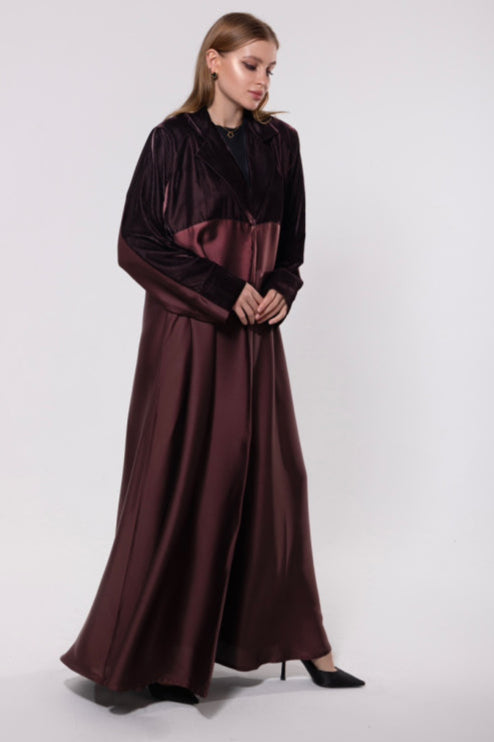 Deep maroon abaya made from a velvet and silk blend, featuring a flowing, luxurious silhouette for an elegant look.