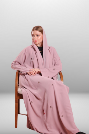 Soft blush pink abaya made from lightweight premium fabric, offering a delicate and elegant silhouette.