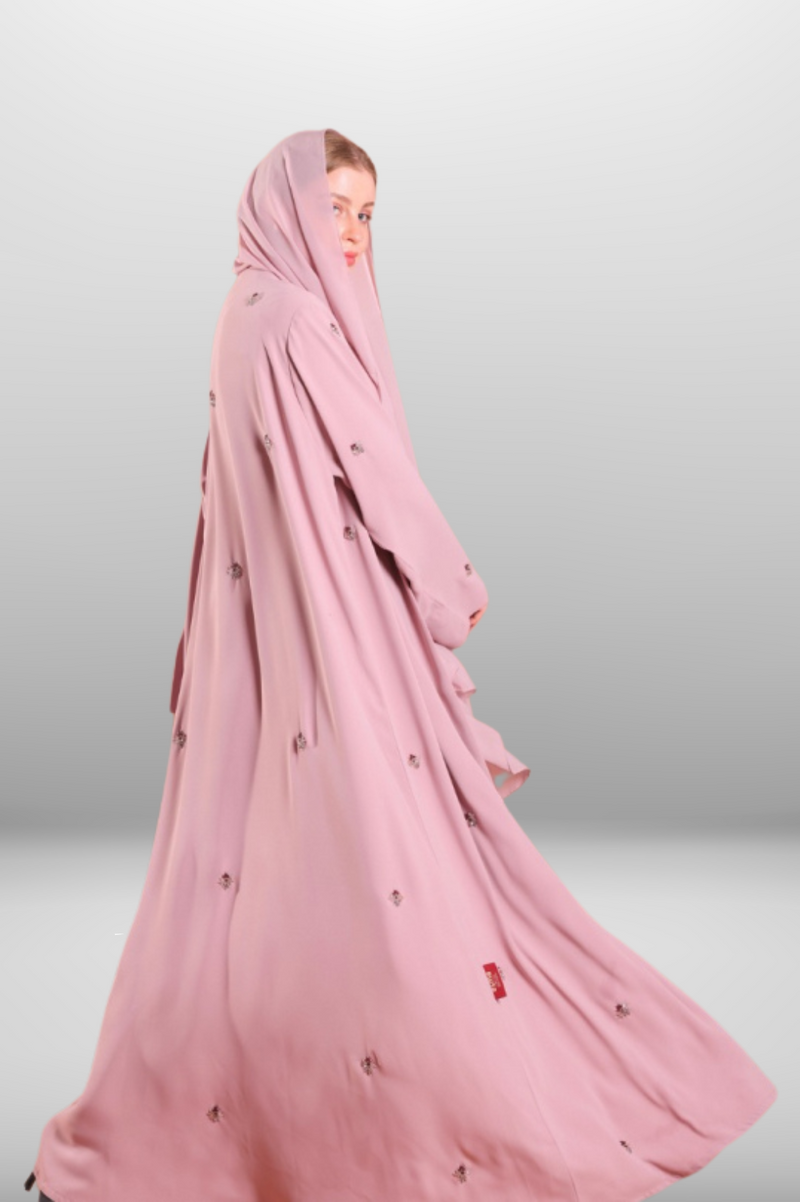 Soft blush pink abaya made from lightweight premium fabric, offering a delicate and elegant silhouette.