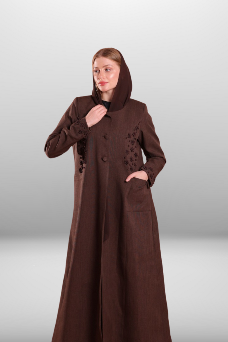 Deep brown coat-style abaya with front buttons, side pockets, and hand-embroidered detailing for a refined and stylish look.