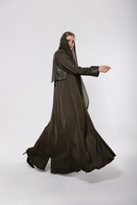 Abaya made from a soft leather and pure silk blend in olive-toned or classic dark hues, featuring a flowing modern cut with a rich, textured finish.