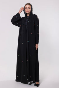 Abaya inspired by the mystique of cosmic dust, featuring soft, luminous fabric with a delicate shine in neutral or metallic hues.