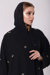 Abaya inspired by the mystique of cosmic dust, featuring soft, luminous fabric with a delicate shine in neutral or metallic hues.
