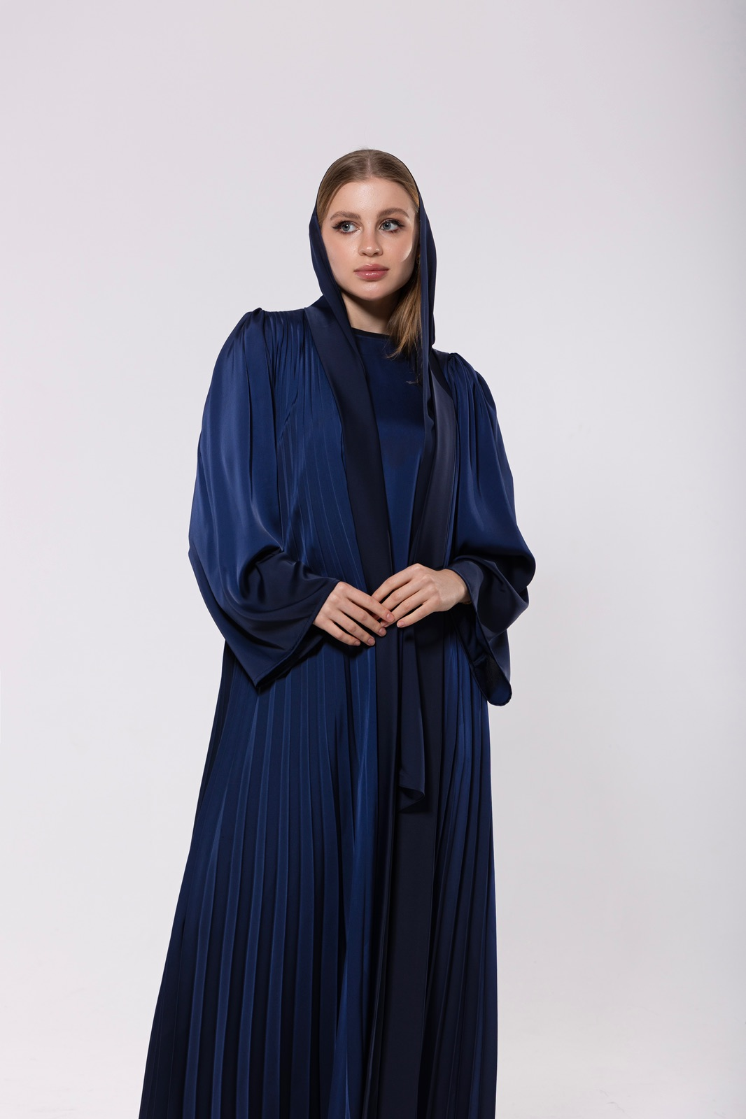 Blue blur abaya made from flowing, soft silk, featuring back pleats for graceful movement and an elegant design.