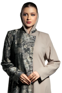 Woman wearing a long, patterned coat over a beige dress on a white background