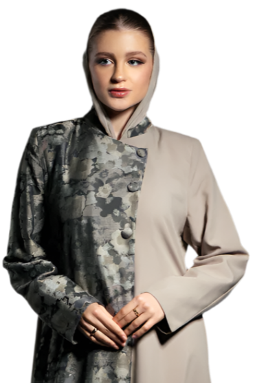 Woman wearing a long, patterned coat over a beige dress on a white background