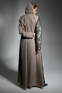 Person wearing a long, light brown abaya