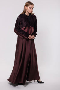 Deep maroon abaya made from a velvet and silk blend, featuring a flowing, luxurious silhouette for an elegant look.