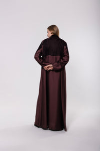 Deep maroon abaya made from a velvet and silk blend, featuring a flowing, luxurious silhouette for an elegant look.