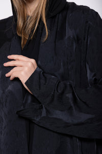 Deep black or navy abaya with mixed matte and glossy finishes, crafted from dual-textured premium material for a sophisticated look.