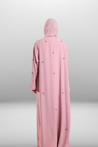 Soft blush pink abaya made from lightweight premium fabric, offering a delicate and elegant silhouette.