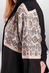 Premium black abaya with beige embroidered panel, combining luxurious fabric with intricate detailing for a refined look.