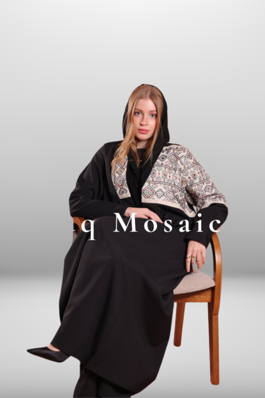 Premium black abaya with beige embroidered panel, combining luxurious fabric with intricate detailing for a refined look.