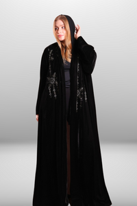 Deep black abaya with intricate embroidered detailing, showcasing luxurious velvet fabric and traditional craftsmanship.