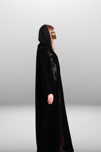 Deep black abaya with intricate embroidered detailing, showcasing luxurious velvet fabric and traditional craftsmanship.