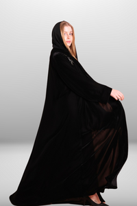 Deep black abaya with intricate embroidered detailing, showcasing luxurious velvet fabric and traditional craftsmanship.