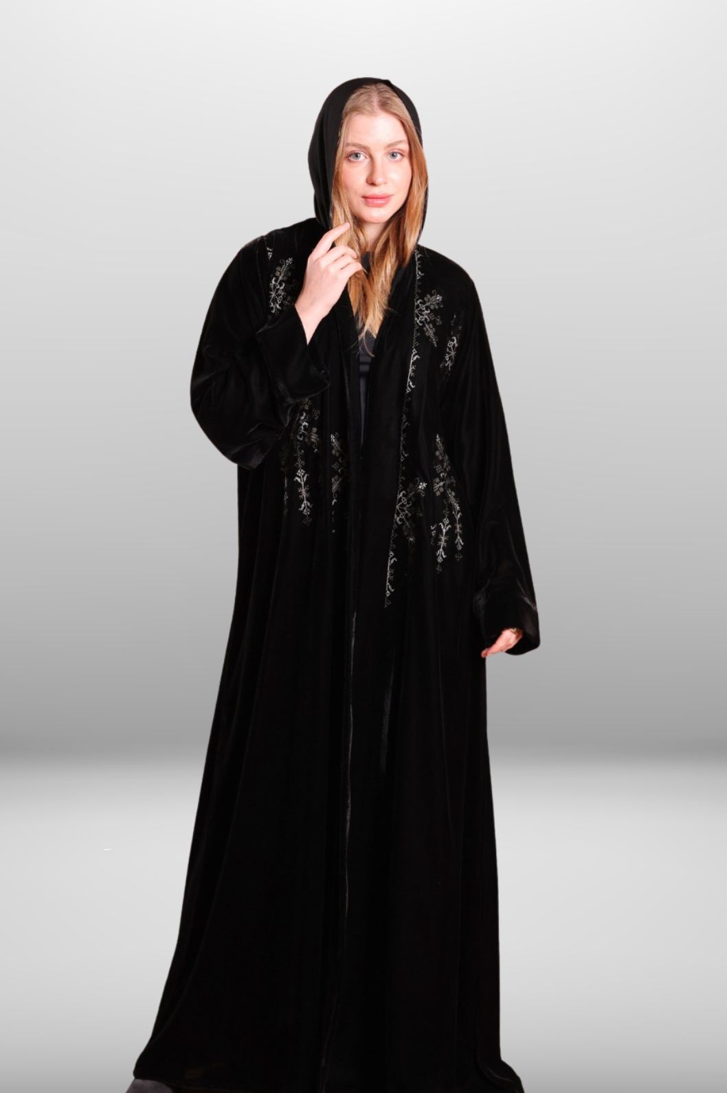 Deep black abaya with intricate embroidered detailing, showcasing luxurious velvet fabric and traditional craftsmanship.