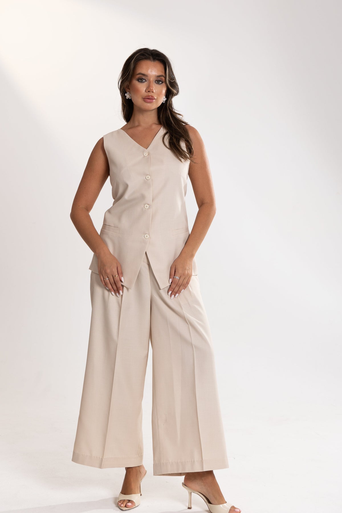 Woman wearing a beige esme Vest and Pants Inner Set on a white background