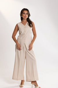 Woman wearing a beige esme Vest and Pants Inner Set on a white background