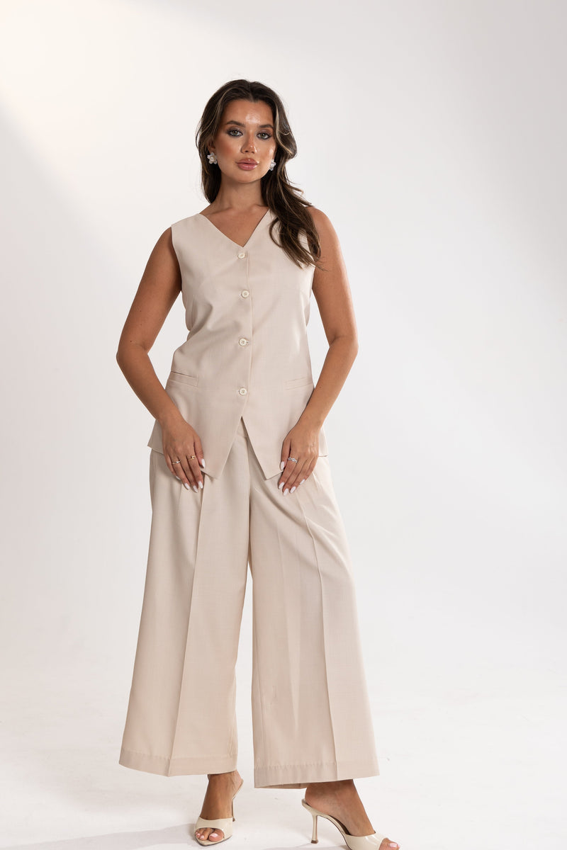 Woman wearing a beige esme Vest and Pants Inner Set on a white background