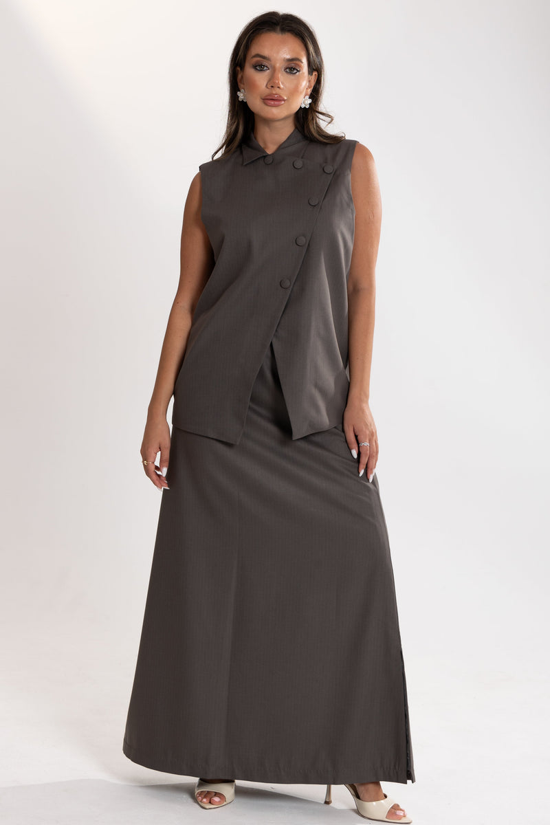 Woman wearing Esme Abaya tailored vest and skirt in elegant fabric