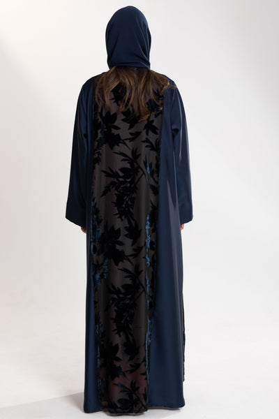 Woman wearing a long blue Esme Abaya with elegant velvet details, showcasing luxury abaya design in Qatar