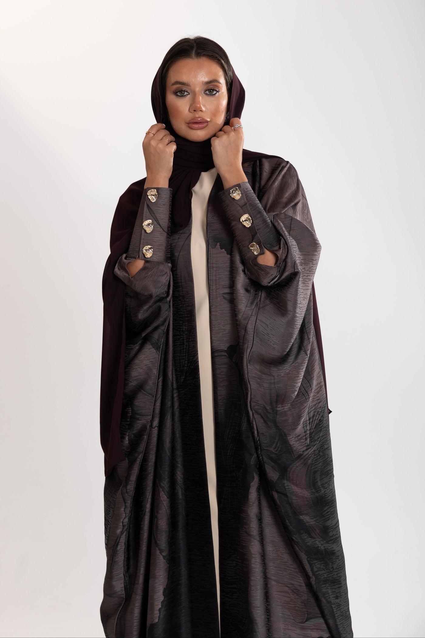 golden button details of ark bisht abaya by esme abaya doha