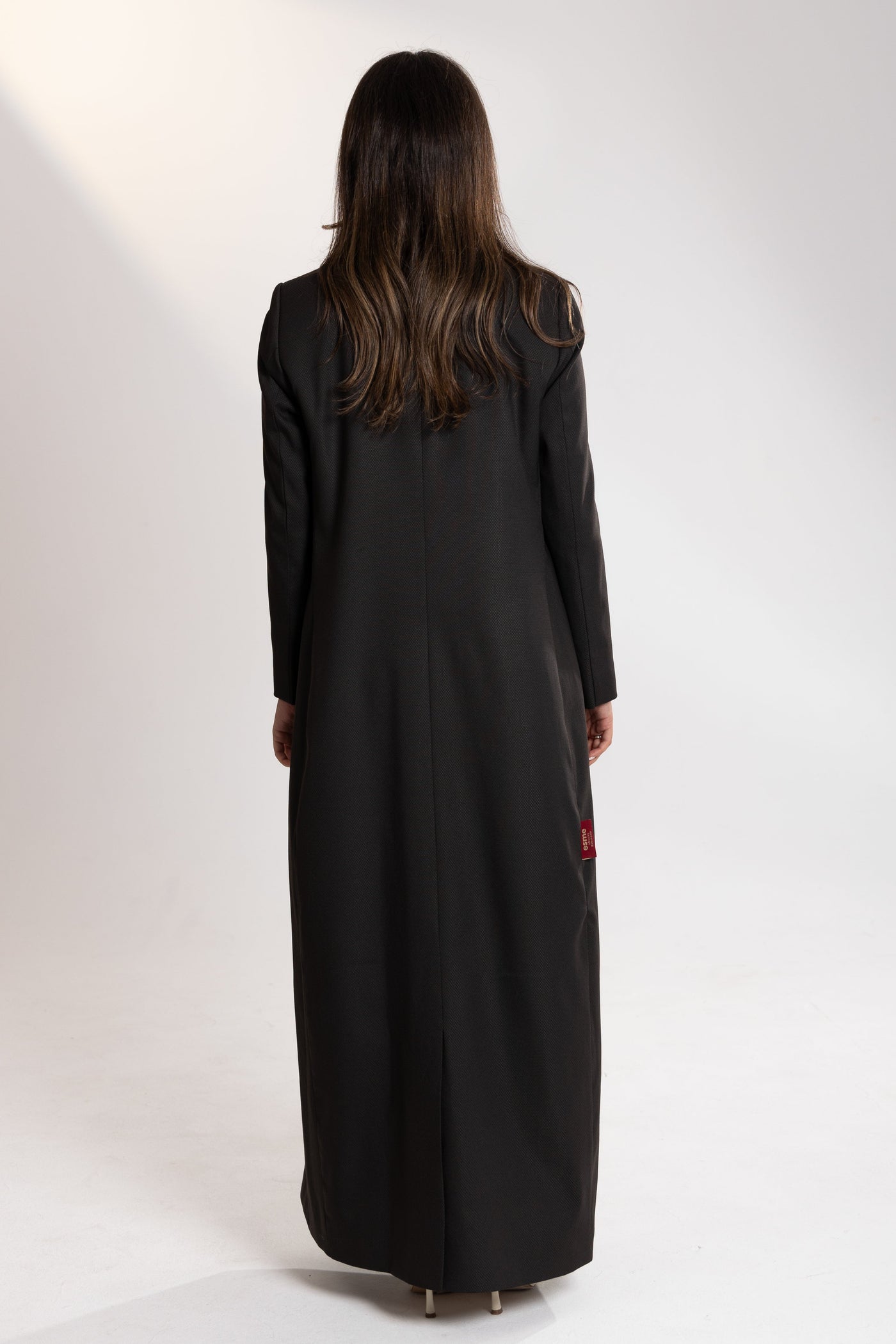 Back angle of Esme Abaya long winter dress, tailored elegant silhouette
