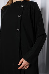 Fabric texture of Bow Charm abaya highlighting premium material and smooth weave