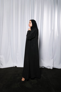 Model wearing Bow Charm abaya in lifestyle setting emphasizing elegance and modest fashion