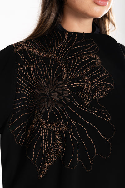 close up of Woman wearing Esme embroidered Abaya from qatar
