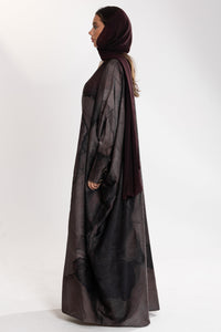 Woman wearing dark esme royal bisht abaya with a matching hijab 