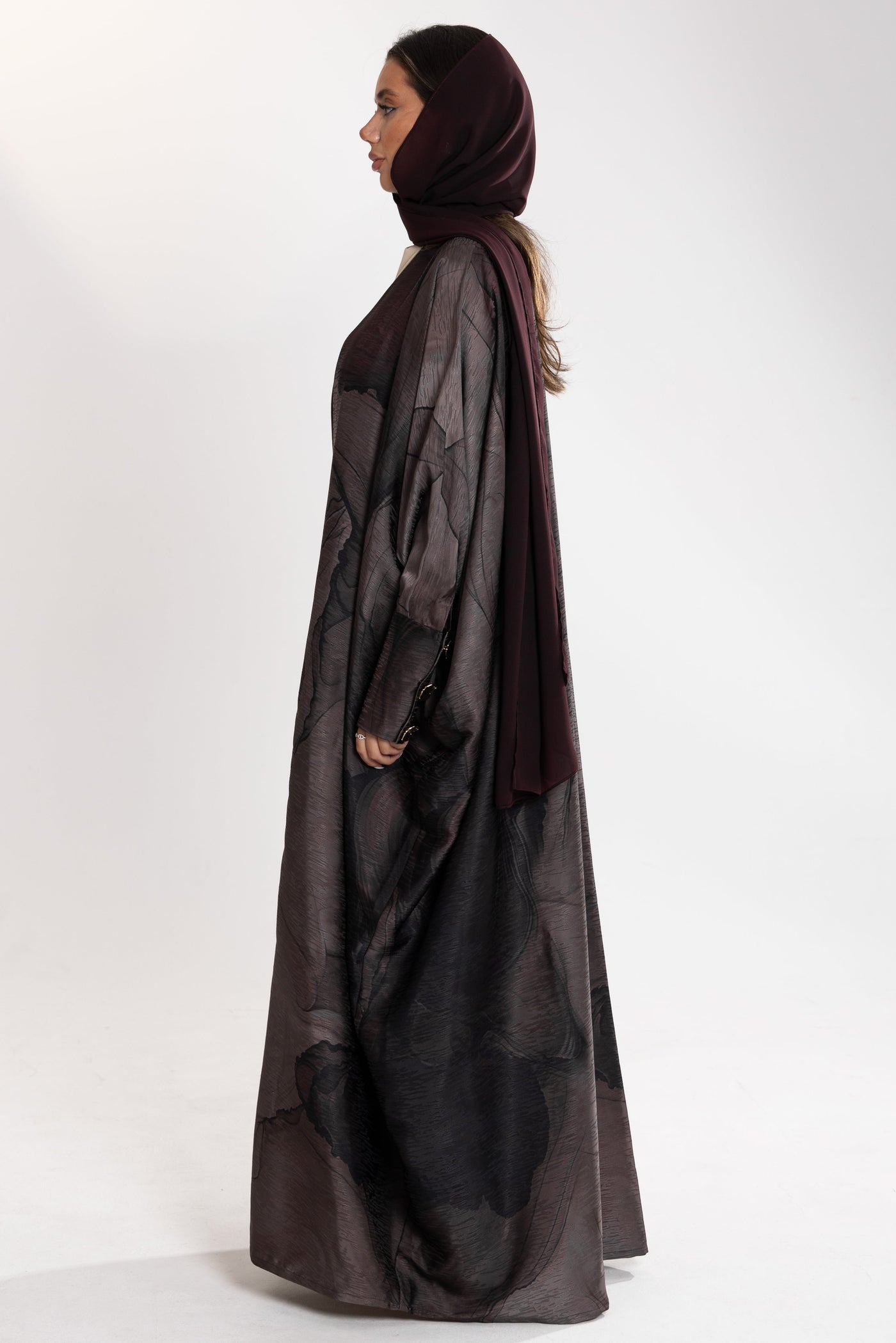 Woman wearing dark esme royal bisht abaya with a matching hijab 