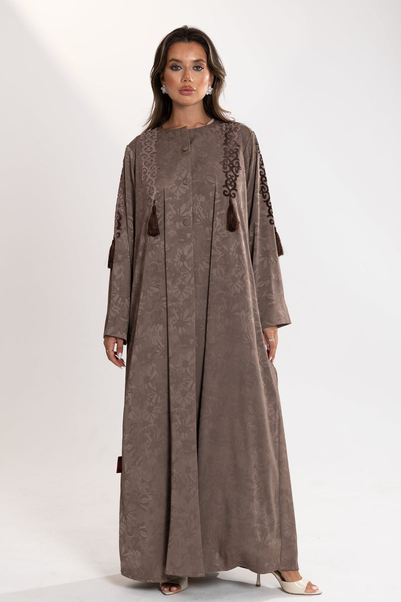 Woman wearing a long brown esme abaya with embroidery 