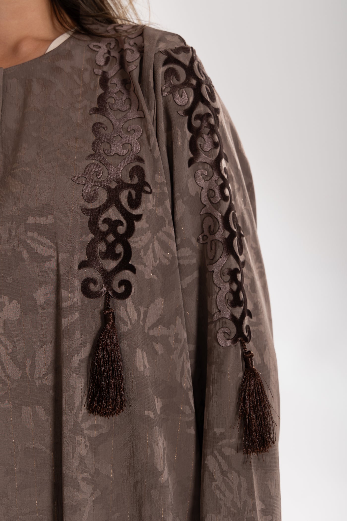 Close-up of a brown embroidered  esme abaya qatar with tassels 