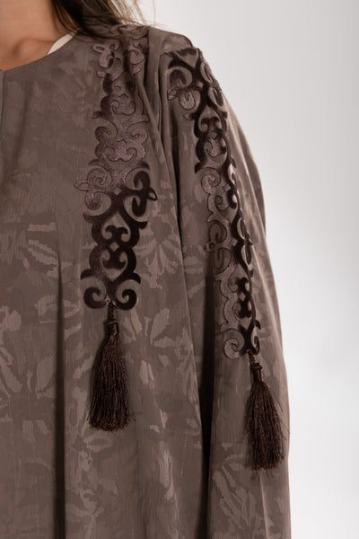 Close-up of a brown embroidered  esme abaya qatar with tassels 