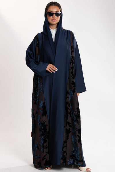 Woman wearing a long blue Esme Abaya with elegant velvet details, showcasing luxury abaya design in Qatar