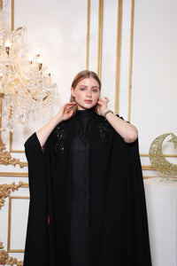 Close up design detail of Esmeabaya Nova Cape highlighting refined tailoring and cape silhouette