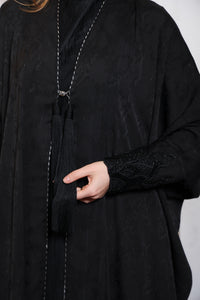 Close up embellishment detail of Esmeabaya Regal Bisht Abaya showcasing luxurious accents
