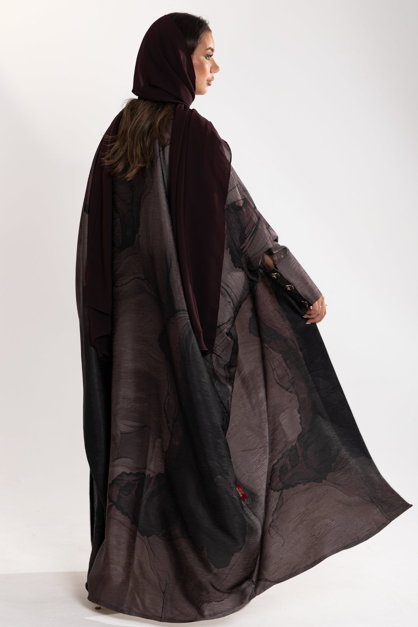 beautiful flowy fabric details of dark bisht abaya by esme abaya qatar