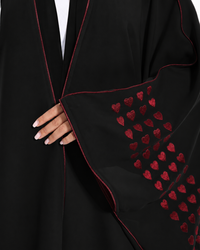 Close-up of embroidered heart detailing and black piping on the Love Notes Bisht Black Variant by Esmeabaya.