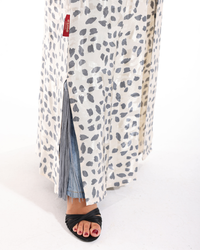 Side profile of the Marble Abaya highlighting its graceful drape, artistic marble pattern, and relaxed elegant fit.