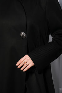Minimalistic abaya worn closed showing sleek front panel and understated design