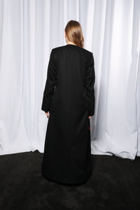 Model wearing Minimalistic abaya in lifestyle setting emphasizing contemporary modest fashion