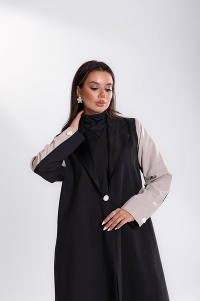 side angle of Woman wearing Esme black and white blazer Abaya from doha