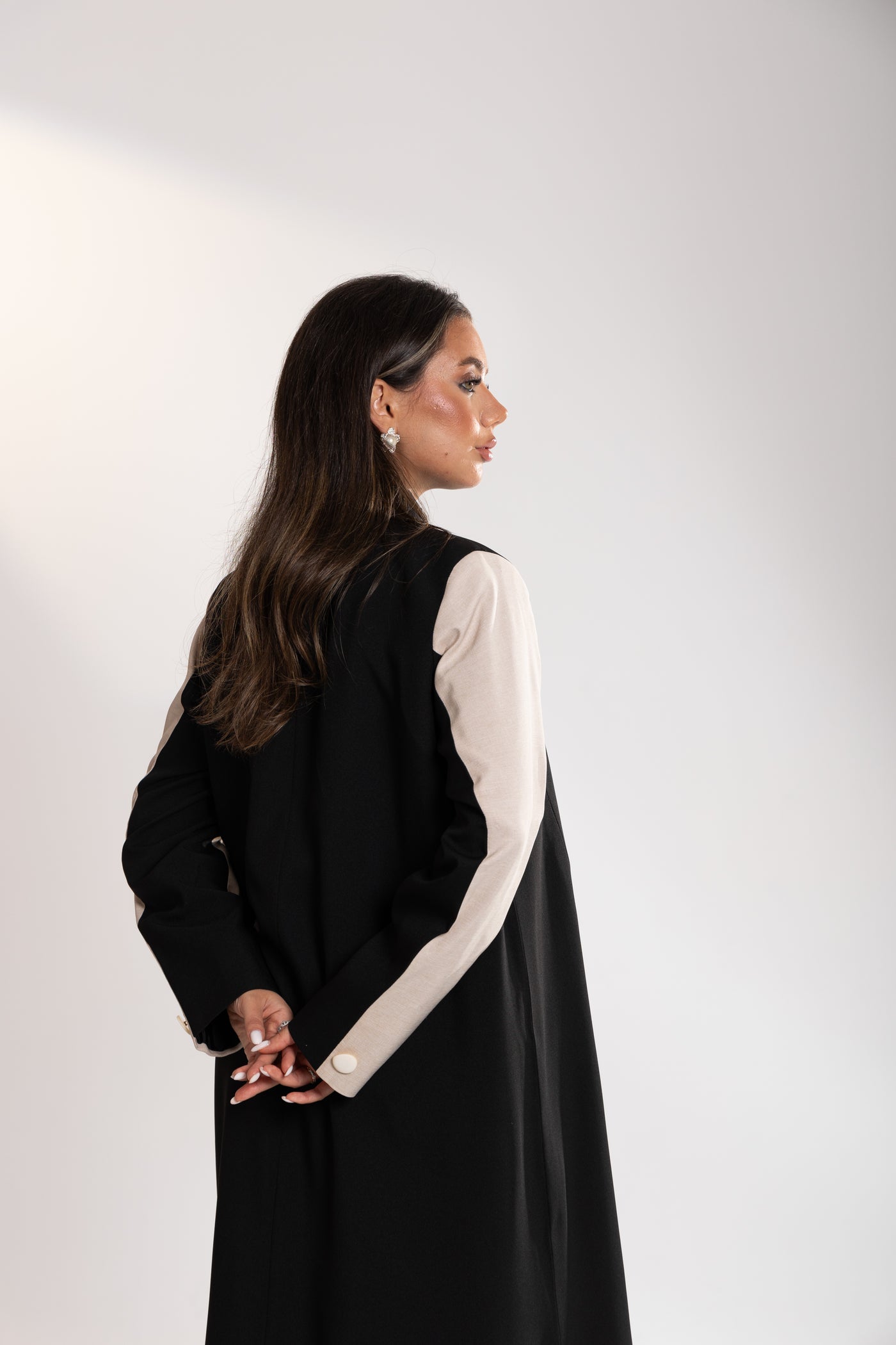 side angle of Woman wearing Esme black blazer Abaya from doha
