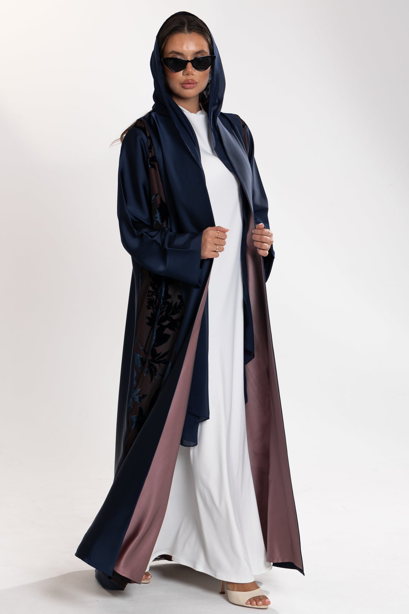 Woman wearing a long blue Esme Abaya with elegant velvet details, showcasing luxury abaya design in Qatar